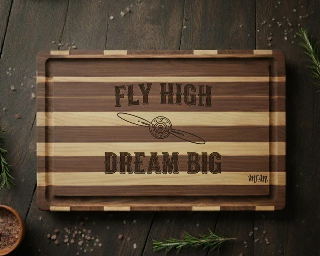 Personalized engraved Pilot charcuterie board with "Fly High Dream Big" quote, made of acacia wood, perfect for aviation-themed gifts.