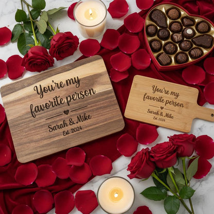 Personalized couple cutting board from The Present Spot, made of acacia wood, ideal for anniversary and Valentine's Day gifts.