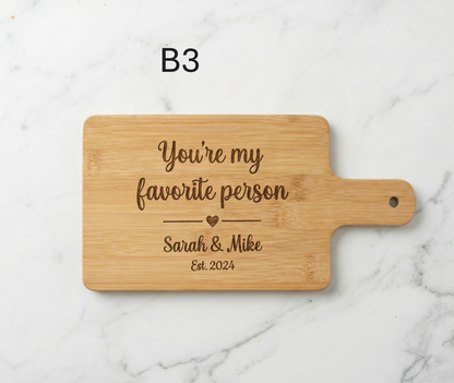 Personalized couple cutting board by The Present Spot, acacia wood, 14x10 inches, ideal for anniversary or Valentine's Day gift.