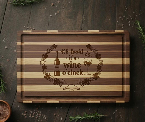 Acacia wood serving cutting board with "Oh Look It’s Wine O’Clock" quote, ideal for wine lovers, by The Present Spot.
