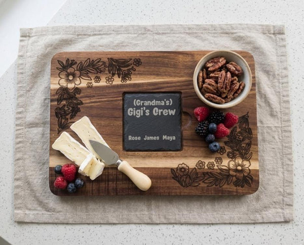 Personalized serving and cutting board with slate inlay from The Present Spot, featuring a smooth wooden surface and customizable inscription.