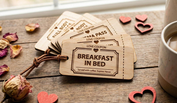 Set of 10 personalized wooden love coupons from The Present Spot, featuring custom date night vouchers and tokens on engraved wood.